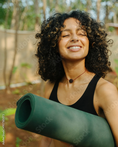 A  yoga practitioner woman smiling to the sun photo