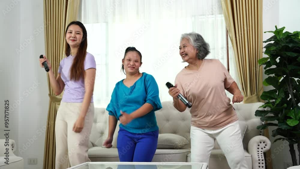 Asian family mother and her eldest and youngest daughters with Down syndrome are happily enjoying themselves holding microphones and singing karaoke together at home Asian family mother and her eldest and youngest daughters with Down syndrome are happily enjoying themselves holding microphones and singing karaoke together at home