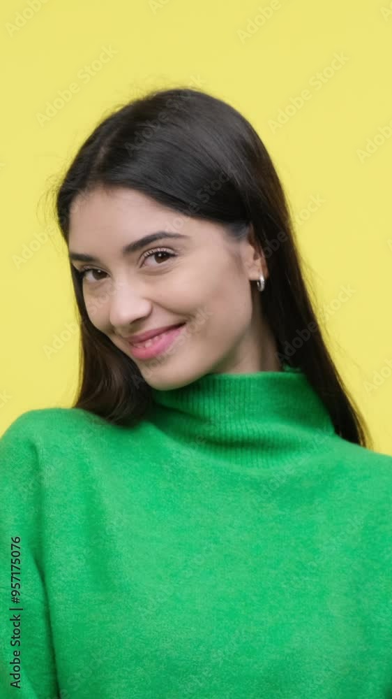 Shy Caucasian young adult woman hiding eyes, while standing on yellow background. Confusion, embarrassment, delight. Vertical video. Shy Caucasian young adult woman hiding eyes, while standing on yellow background. Confusion, embarrassment, delight. Vertical video.