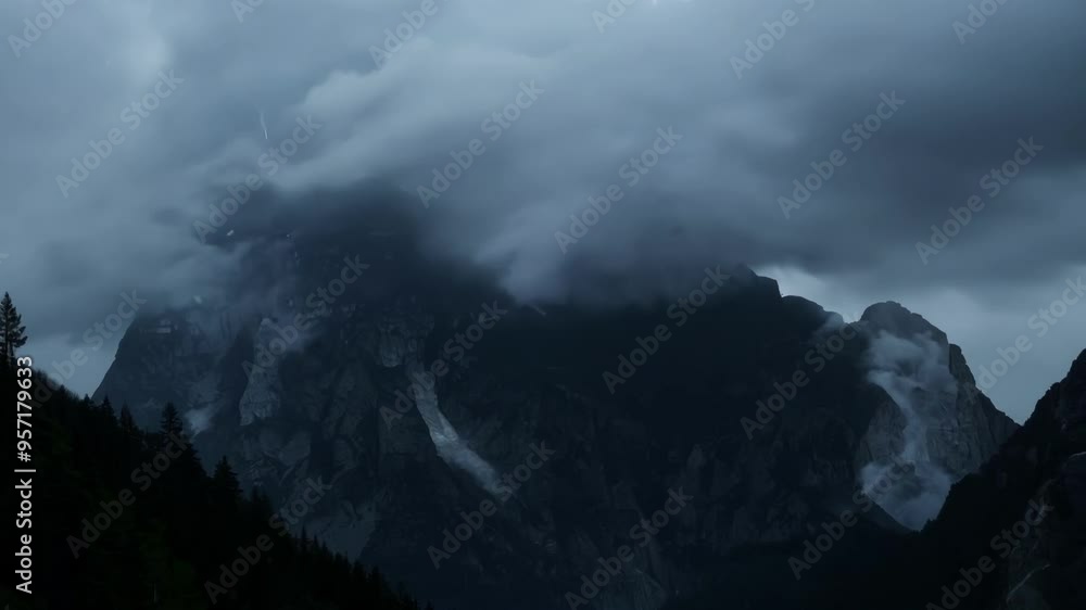 Dark, imposing mountain peaks partially obscured by clouds and mist, illuminated by the faint glow of twilight, with a shadowy forest in the foreground Dark, imposing mountain peaks partially obscured by clouds and mist, illuminated by the faint glow of twilight, with a shadowy forest in the foreground
