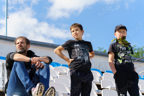 father and sons sports fans