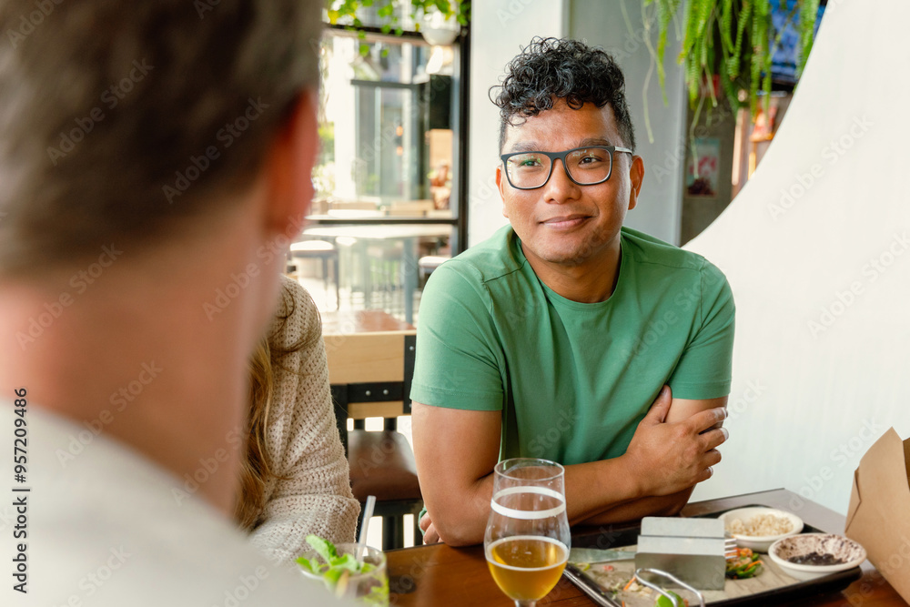 Man Engages with Friends at Brewery Man Engages with Friends at Brewery
