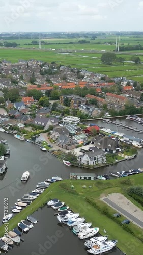 aerial panning shot city town hoogmade, netherlands, rivers, water vessels, boats tranquil waterways charming town, aerial panning scenic dutch town nautical maritime infrastructure photo