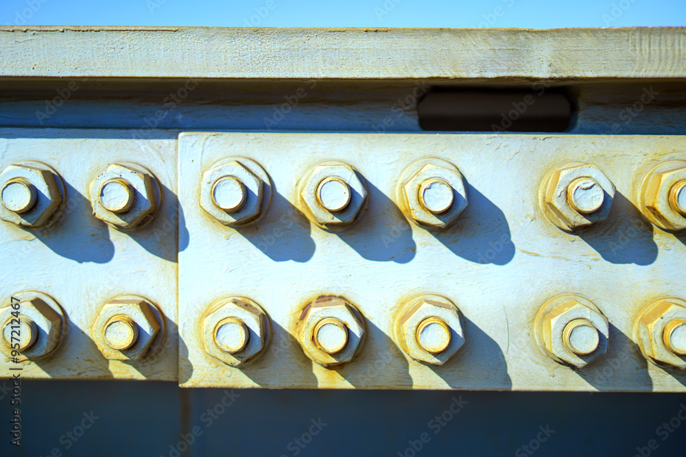 two rows of large bolts and nuts, integral for securing bridge metal ...