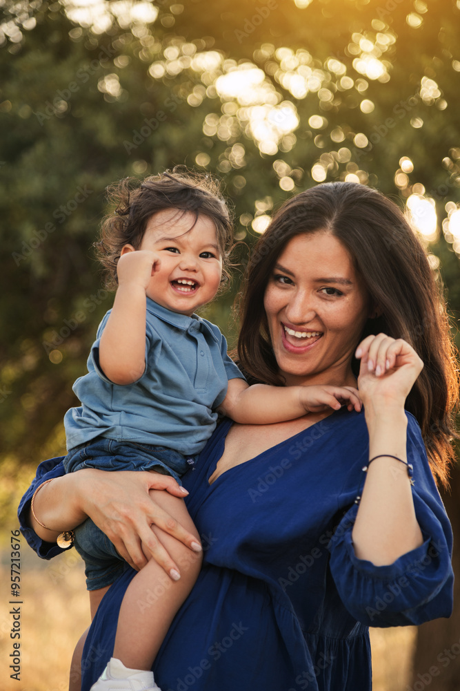 Naklejka premium Mother Holding Her One Year Old Son in Nature