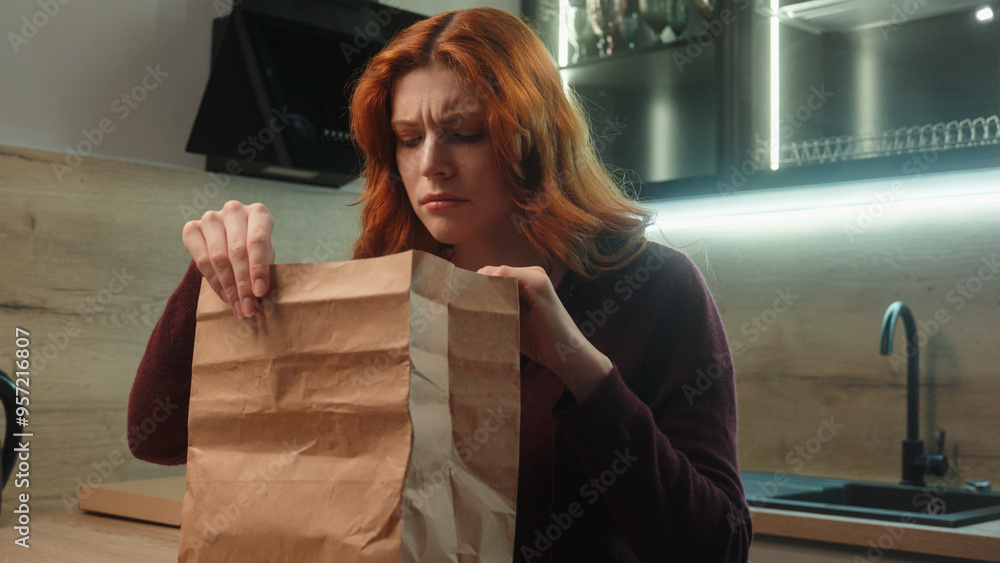 Fototapeta premium Shocked disgusted Caucasian hungry woman female client girl customer unpacking open paper bag order package sniff spoiled stink order bad smelling dish dislike smell feel nausea disgust indoor kitchen