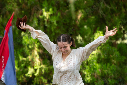 Young actress performing renaissance reenactment outdoors photo