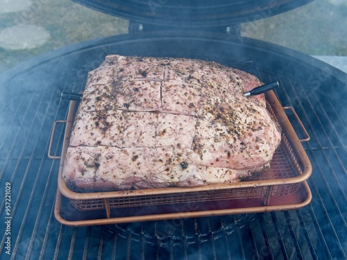 Pork shoulder smoked on a charcoal grill for pulled pork