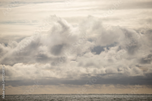 Blue sea and blue sky with white clouds. Seascape.