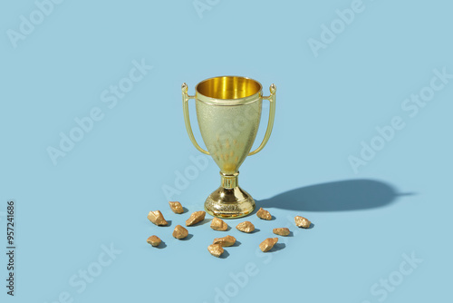 Fragments of gold laying close to metal winner goblet