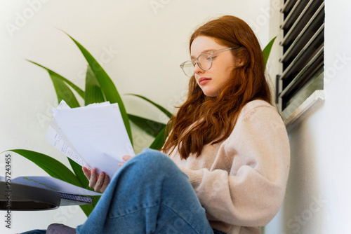 Girl Reading Study Notes with eyeglasses
 photo