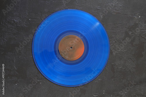 Blue Vinyl record on a black background. Retro style. Top view.
