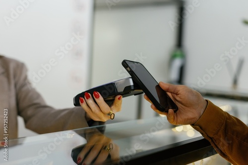 Partial of woman paying for booking room at reception desk in hotel