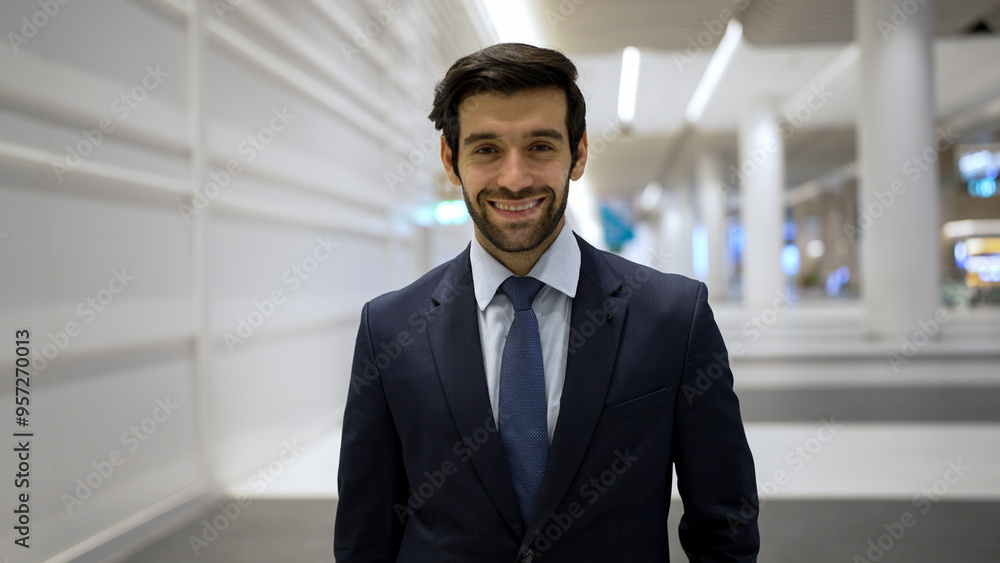 Smiling business man looking at camera while standing at white background. Closeup of successful man smiling at camera while wearing business suit. Happy executive manager look at camera. Exultant. Smiling business man looking at camera while standing at white background. Closeup of successful man smiling at camera while wearing business suit. Happy executive manager look at camera. Exultant.