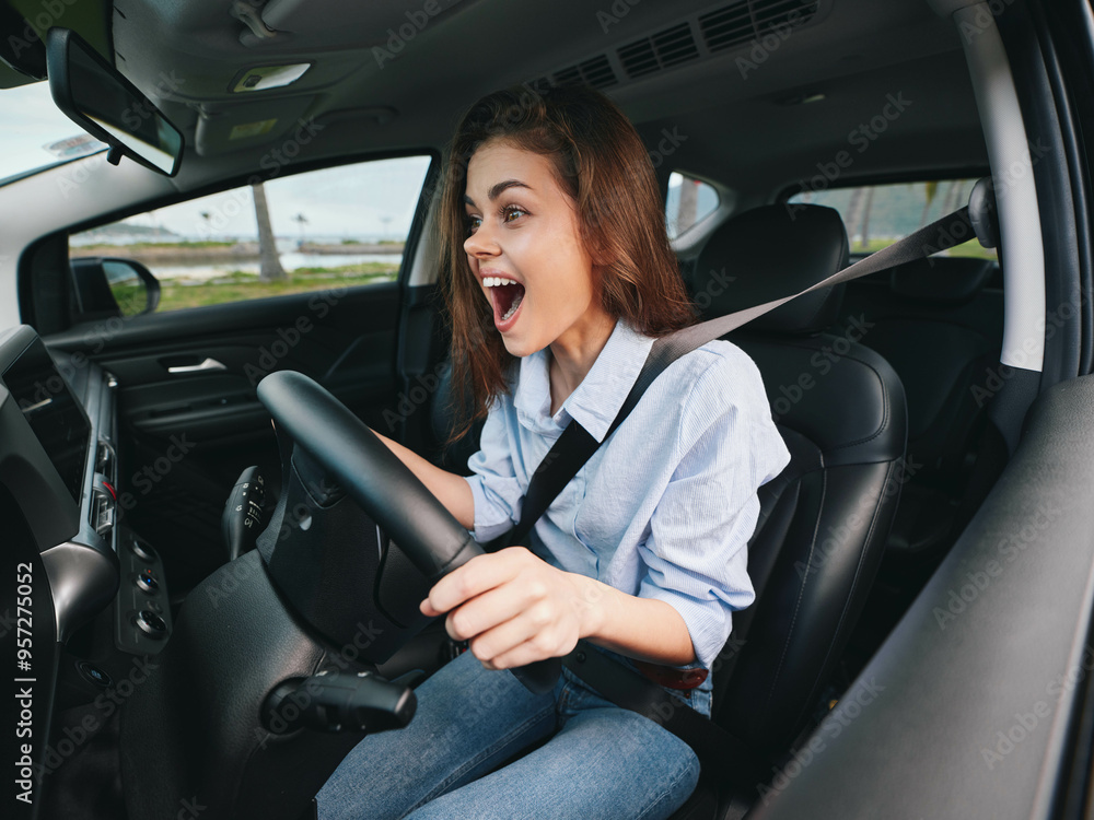 Woman driving a car, mouth wide open, hands on steering wheel, eyes wide in surprise, looking at the camera, capturing a moment of shock or excitement while driving Woman driving a car, mouth wide open, hands on steering wheel, eyes wide in surprise, looking at the camera, capturing a moment of shock or excitement while driving