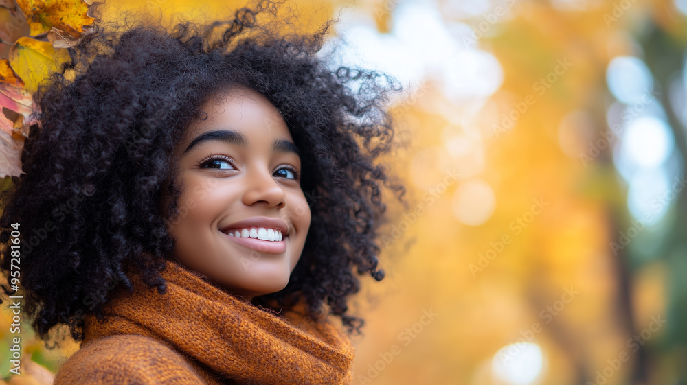 Portrait of young happy smiling black girl in autumn park, positive cheerful young woman enjoying a walk outdoors in autumn forest. Active lifestyle, good health. Enjoying outdoors. Portrait of young happy smiling black girl in autumn park, positive cheerful young woman enjoying a walk outdoors in autumn forest. Active lifestyle, good health. Enjoying outdoors.