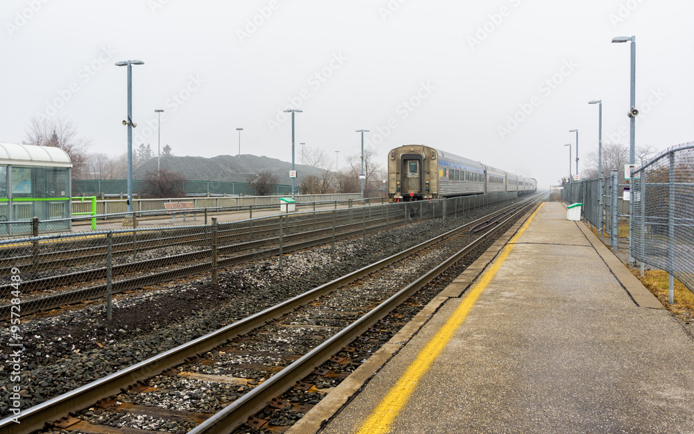 Fototapeta premium Train passing through a station on a foggy winter day in Toronto, Canada