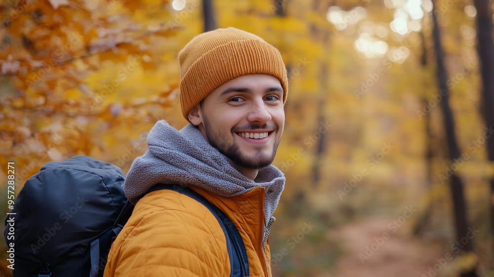 Portrait of young happy smiling caucasian man in autumn park, positive cheerful young man enjoying a walk outdoors in autumn forest. Active lifestyle, good health. Enjoying outdoors. Portrait of young happy smiling caucasian man in autumn park, positive cheerful young man enjoying a walk outdoors in autumn forest. Active lifestyle, good health. Enjoying outdoors.