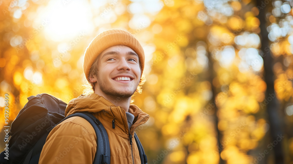 Portrait of young happy smiling caucasian man in autumn park, positive cheerful young man enjoying a walk outdoors in autumn forest. Active lifestyle, good health. Enjoying outdoors. Portrait of young happy smiling caucasian man in autumn park, positive cheerful young man enjoying a walk outdoors in autumn forest. Active lifestyle, good health. Enjoying outdoors.