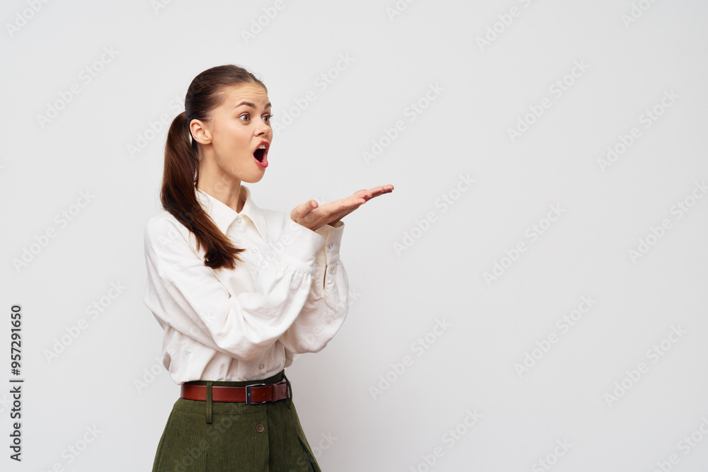 surprised young woman in white shirt gesturing with hand, showcasing emotions, casual outfit, light background, expression of excitement and enthusiasm surprised young woman in white shirt gesturing with hand, showcasing emotions, casual outfit, light background, expression of excitement and enthusiasm