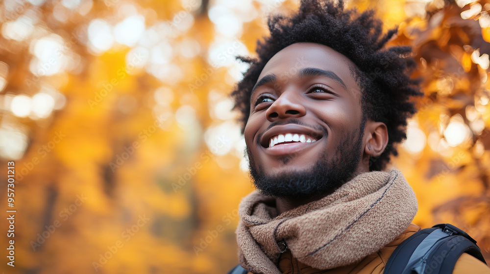 Portrait of young happy smiling black man in autumn park, positive cheerful young man enjoying a walk outdoors in autumn forest. Active lifestyle, good health. Enjoying outdoors. Portrait of young happy smiling black man in autumn park, positive cheerful young man enjoying a walk outdoors in autumn forest. Active lifestyle, good health. Enjoying outdoors.