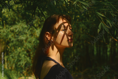 a portrait of a young woman in a bamboo shadow photo