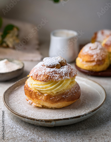 Swedish semla, bun with whipped cream on a plate. Tasty dessert. Delicious sweet food.