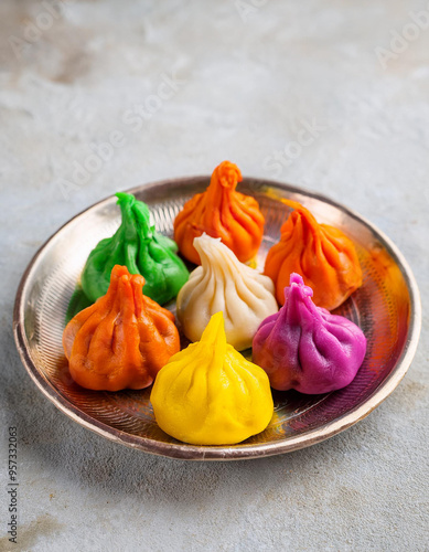 Colorful Ukadiche Modak sweet rice dumplings. Traditional Indian food. Ganesh Chaturthi Festival. photo