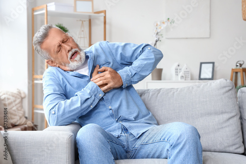 Mature man having heart att...