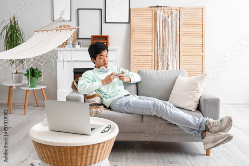 Young Asian man using mobil...