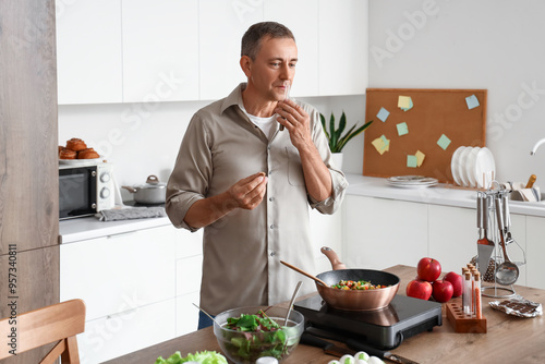 Mature man smelling spices ...