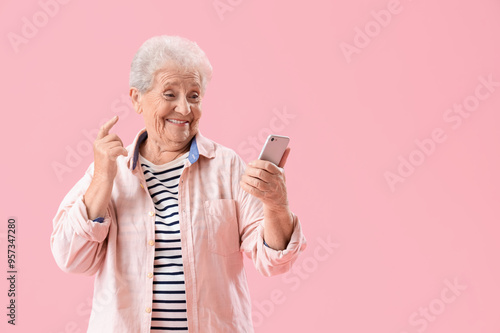 Happy senior woman using mo...