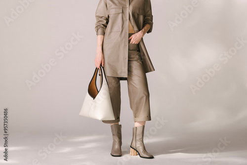 Stylish Woman in Beige Outfit Holding Designer Handbag