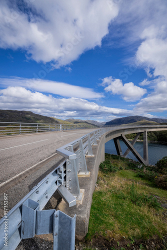 The image is of the Kylesku Bridge in Scotland, which spans Loch a' Chàirn Bhàin in Sutherland. It is a concrete bridge. 