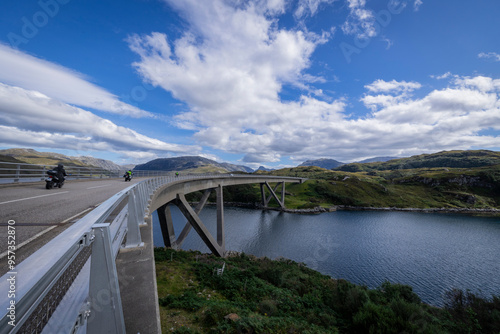 The image is of the Kylesku Bridge in Scotland, which spans Loch a' Chàirn Bhàin in Sutherland. It is a concrete bridge. 