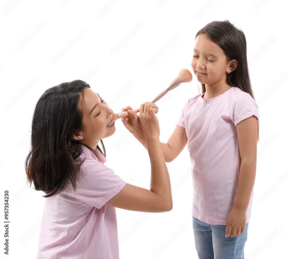 Asian mother with her little daughter and makeup brushes on white background Asian mother with her little daughter and makeup brushes on white background