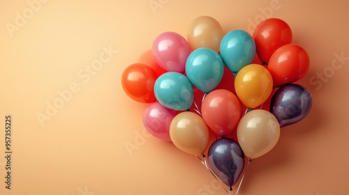 Colorful balloons arranged in a heart shape on a warm peach background expressing love and happiness