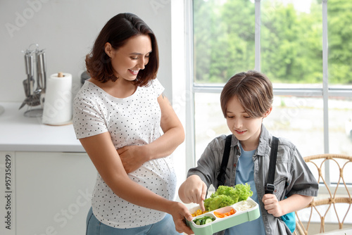 Mother giving tasty lunch t...