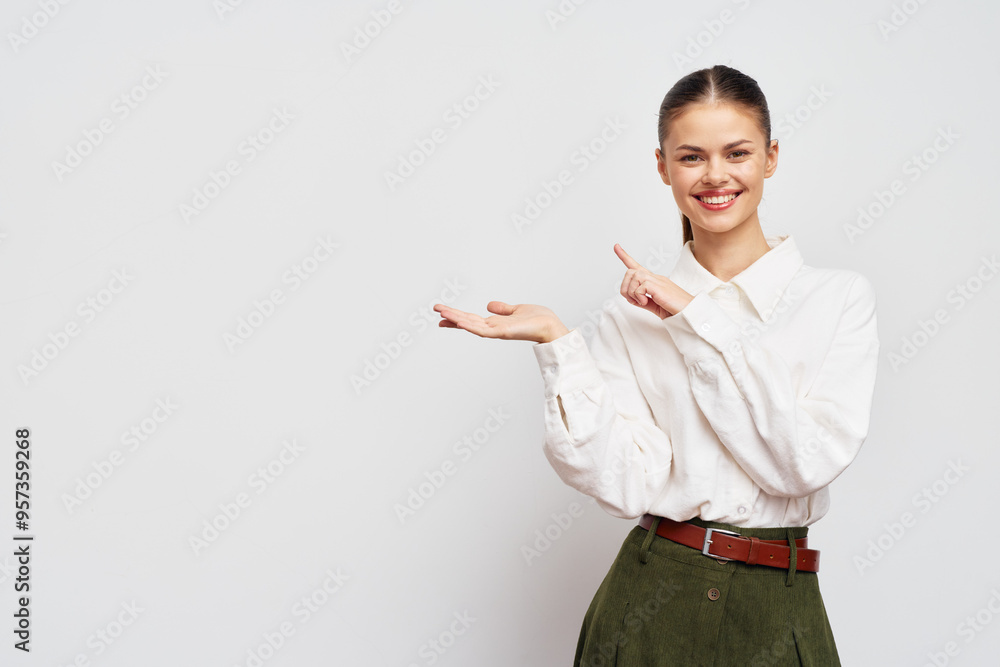 Young woman smiling and gesturing with her hand, using a neutral background to emphasize her friendly demeanor and catchy style Perfect for various marketing and promotional purposes Young woman smiling and gesturing with her hand, using a neutral background to emphasize her friendly demeanor and catchy style Perfect for various marketing and promotional purposes