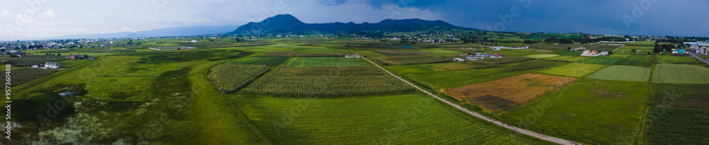 Panoramic aerial photography made with a drone from 6 images, of the Ixtlahuca State of Mexico countryside, where mountains, cornfields, and old houses can be seen. Panoramic aerial photography made with a drone from 6 images, of the Ixtlahuca State of Mexico countryside, where mountains, cornfields, and old houses can be seen.