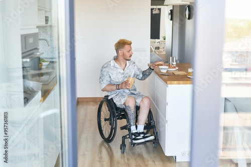Foto Person eating breakfast while sitting in wheelchair in modern kitchen setting with wooden floor