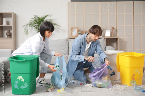 Young couple with garbage c...