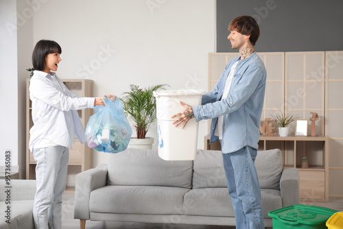 Young couple with garbage c...