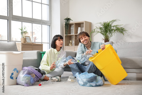 Young couple with garbage c...