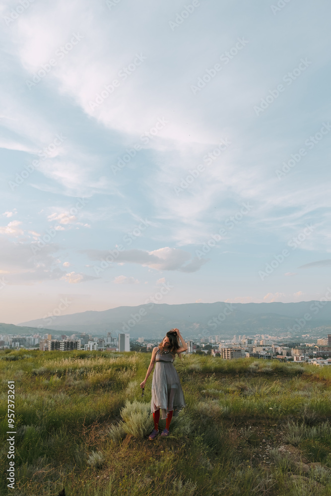 Woman Walking Away From Cityscape at Sunset Woman Walking Away From Cityscape at Sunset