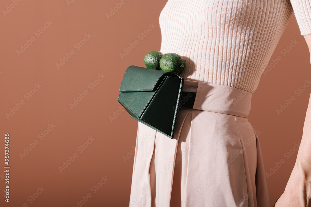 © Ulas&Merve/Stocksy - Stylish Woman Wearing Green Handbag With Limes On Belt © Ulas&Merve/Stocksy - Stylish Woman Wearing Green Handbag With Limes On Belt