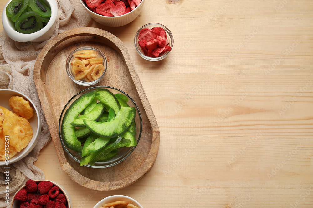 Bowls of different dehydrated fruits and berries on wooden background Bowls of different dehydrated fruits and berries on wooden background