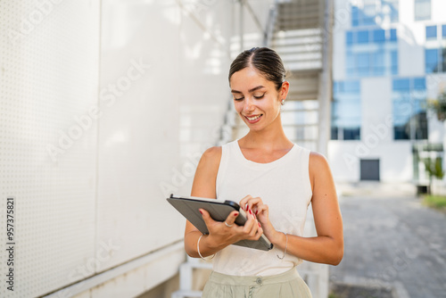 Young woman stand in front white background and use digital tablet Free Download Young woman stand in front white background and use digital tablet - GFXLoad