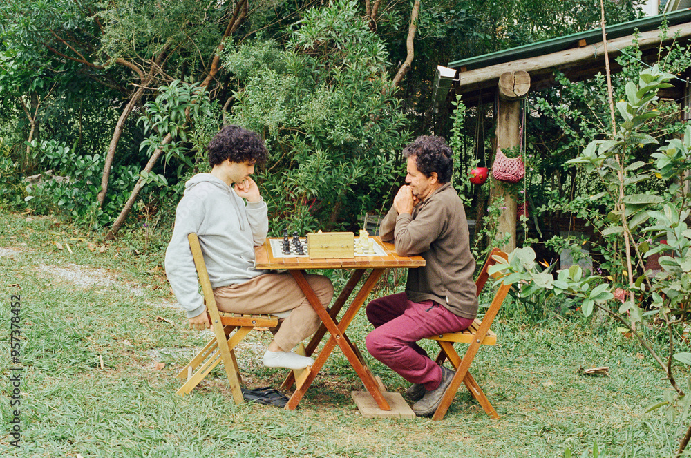 Two men playing chess outside in nature Two men playing chess outside in nature