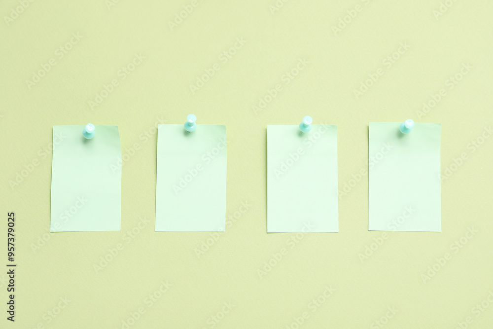 Paper notes pinned on green background Paper notes pinned on green background